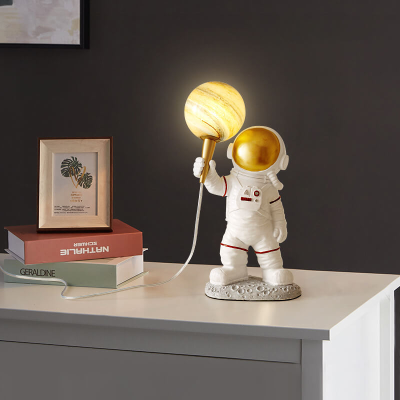 Kreativer Cartoon-Astronaut, der Jupiter 1-Licht-Harz-Tischlampen hält 